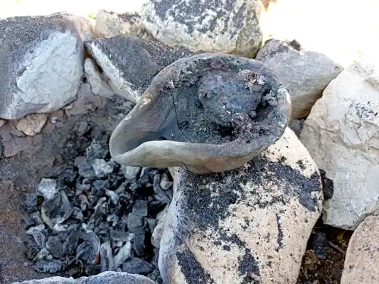 Small crucible or furnace with charcoal remains